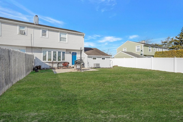 rear view of property featuring a yard, a patio area, and central air condition unit