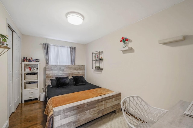 bedroom with dark hardwood / wood-style floors