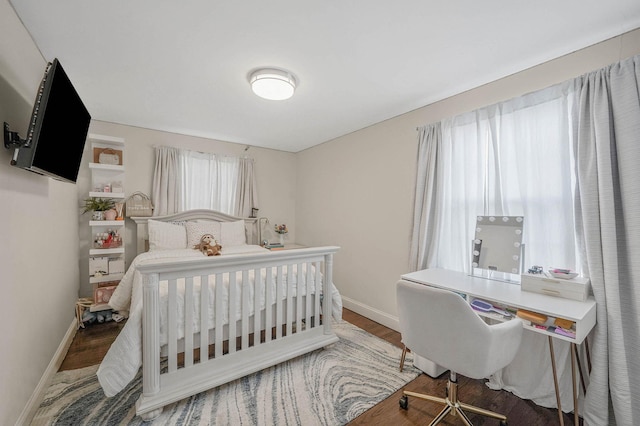 bedroom with hardwood / wood-style flooring