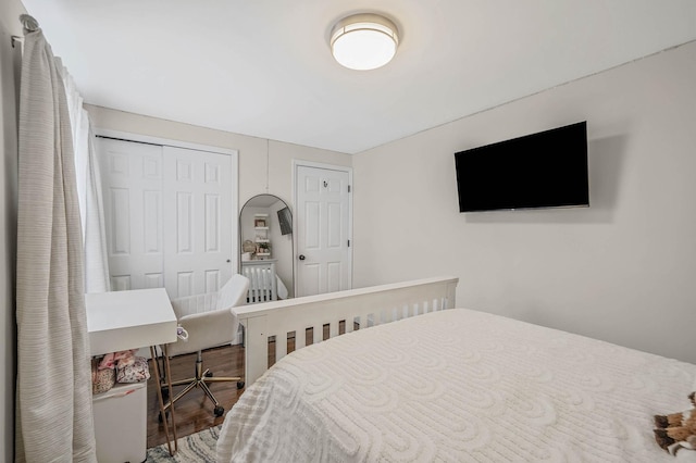 bedroom with hardwood / wood-style flooring and a closet