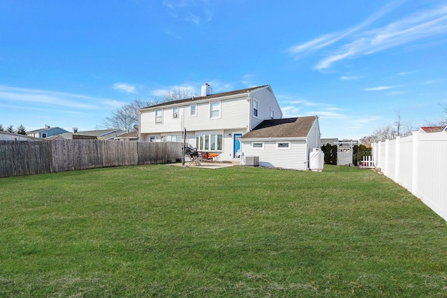 back of property featuring a yard, central air condition unit, and a patio area