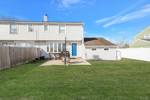 back of property with a patio, a yard, and cooling unit