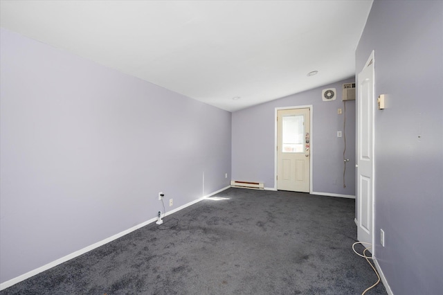 carpeted empty room featuring vaulted ceiling and baseboard heating