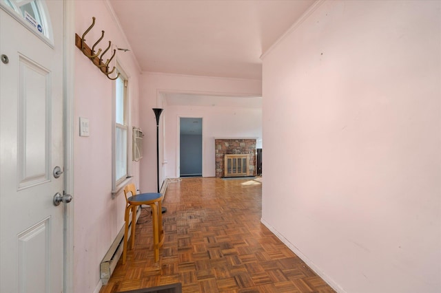 corridor featuring dark parquet flooring, a baseboard heating unit, and ornamental molding