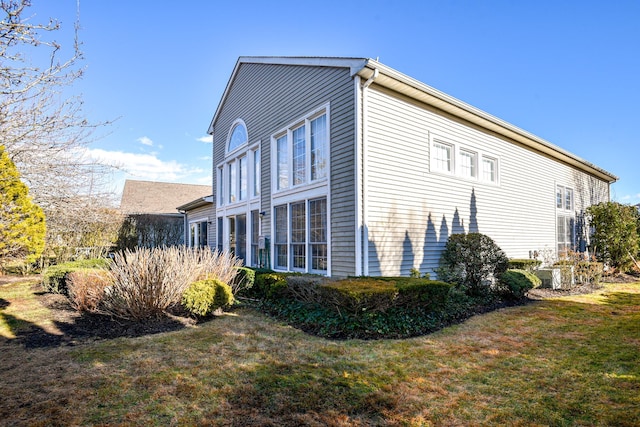 view of side of home featuring a yard