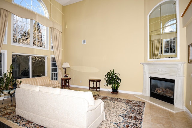 living room featuring light tile patterned floors and a high ceiling