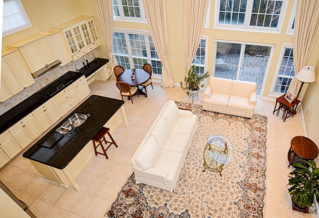 tiled living room featuring a high ceiling