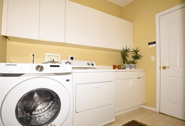 laundry area featuring light tile patterned flooring, independent washer and dryer, and cabinets