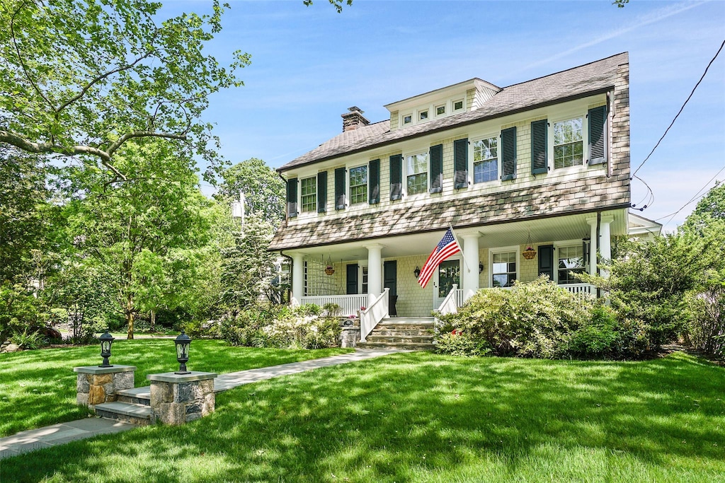 1 Sussex Ave, Bronxville, NY 10708 - view of front of house featuring covered porch and a front yard