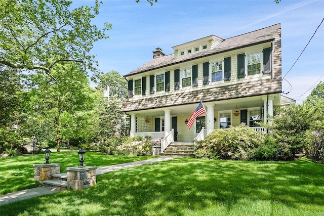 view of front facade with a porch and a front lawn