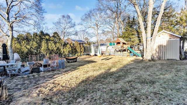 view of yard featuring a storage shed and a playground