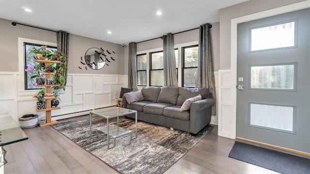 living room featuring a baseboard radiator and wood-type flooring