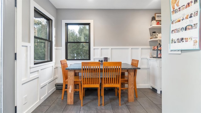 dining space featuring dark tile patterned floors