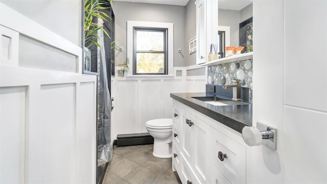 bathroom with tile patterned flooring, vanity, and toilet