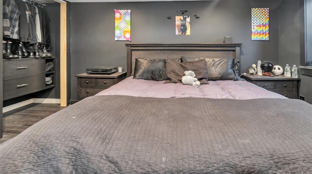 bedroom with dark hardwood / wood-style floors