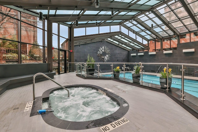 view of swimming pool featuring an indoor in ground hot tub and a patio area