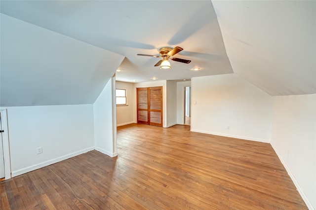 bonus room with lofted ceiling, light hardwood / wood-style floors, and ceiling fan