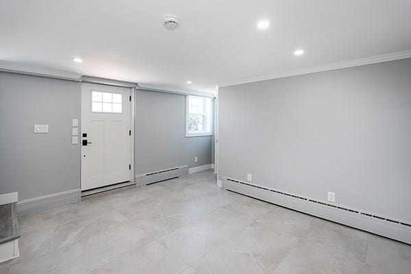 entrance foyer featuring baseboards, a baseboard radiator, and crown molding