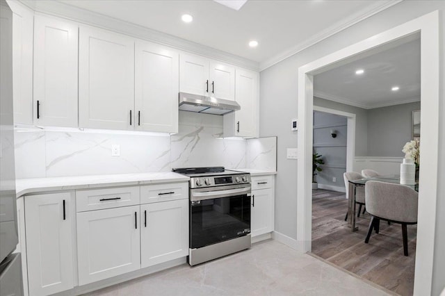 8 Fairway Pl, Cold Spring Harbor, NY 11724 - kitchen with stainless steel range with electric cooktop, under cabinet range hood, crown molding, white cabinets, and recessed lighting