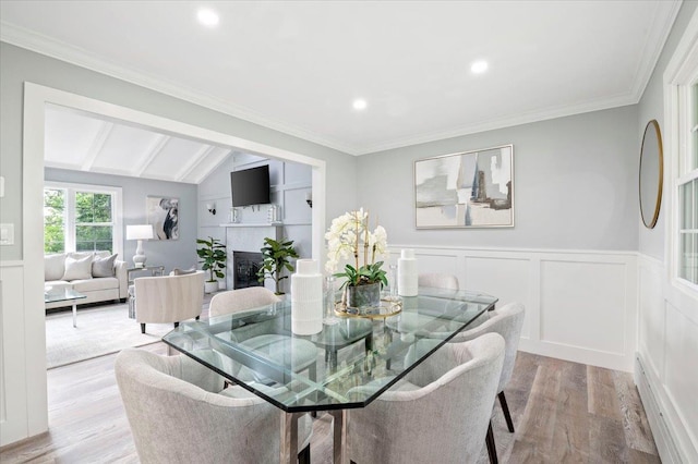 8 Fairway Pl, Cold Spring Harbor, NY 11724 - dining room featuring light wood-type flooring, a wainscoted wall, a fireplace, recessed lighting, and a decorative wall