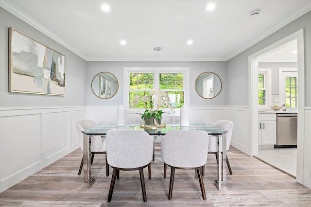 8 Fairway Pl, Cold Spring Harbor, NY 11724 - dining room with crown molding, wainscoting, recessed lighting, a decorative wall, and light wood-style flooring