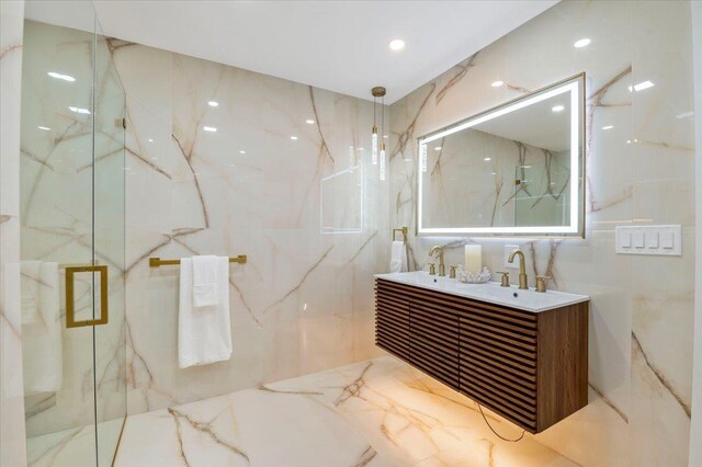 8 Fairway Pl, Cold Spring Harbor, NY 11724 - bathroom with double vanity, a marble finish shower, tile walls, and marble tiled flooring