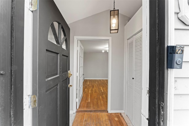 foyer entrance featuring hardwood / wood-style flooring and vaulted ceiling