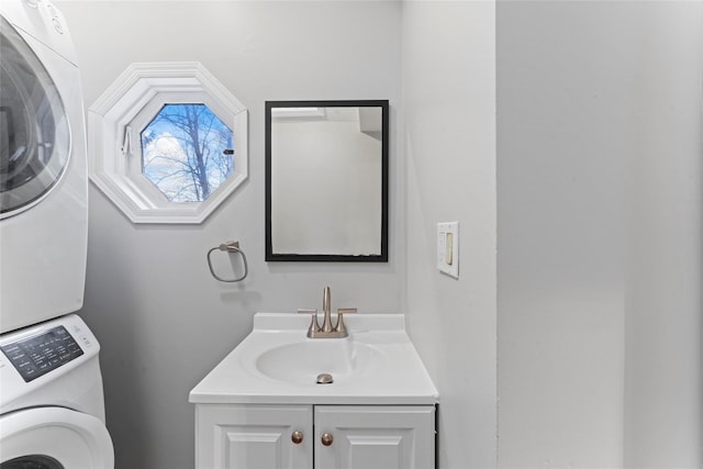 bathroom with vanity and stacked washer and clothes dryer