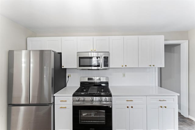 kitchen featuring appliances with stainless steel finishes, white cabinets, and decorative backsplash