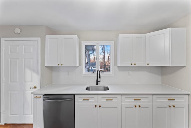 kitchen featuring white cabinets, sink, and dishwashing machine