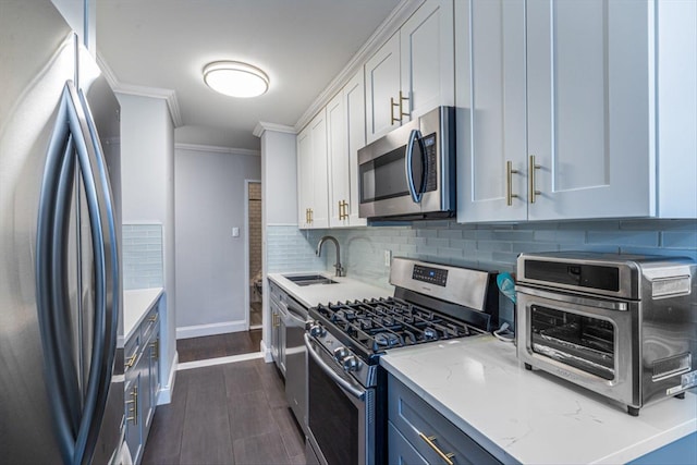 kitchen with sink, crown molding, appliances with stainless steel finishes, light stone countertops, and white cabinets