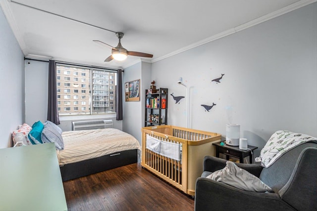 bedroom with a wall mounted air conditioner, crown molding, dark wood-type flooring, and ceiling fan