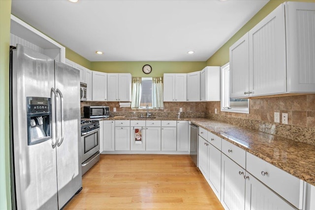 kitchen featuring white cabinetry, sink, and stainless steel appliances