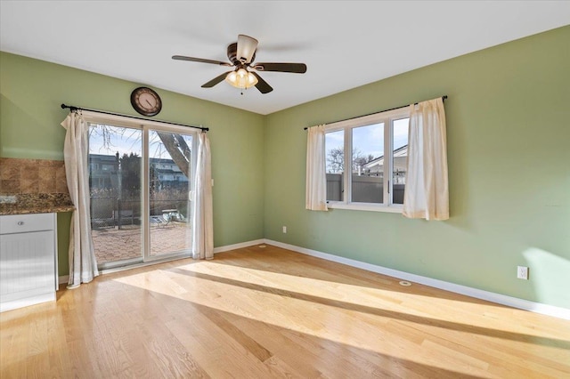 spare room featuring ceiling fan and light hardwood / wood-style floors