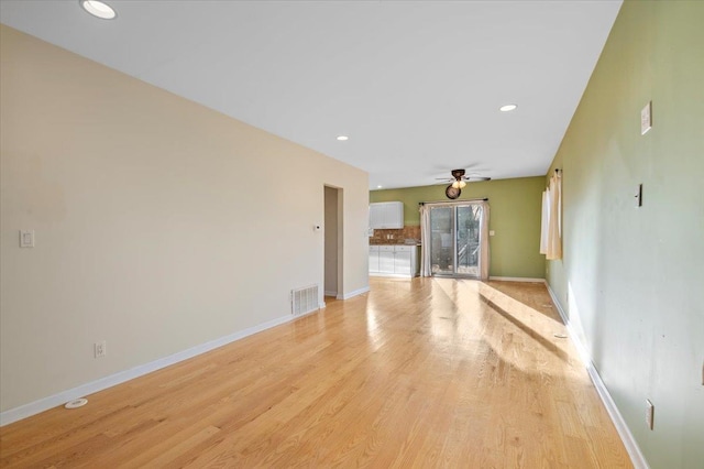 unfurnished living room featuring ceiling fan and light hardwood / wood-style floors