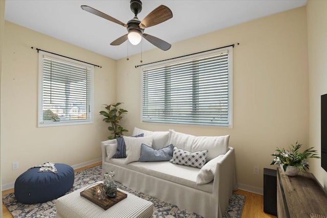 living room featuring hardwood / wood-style floors and ceiling fan