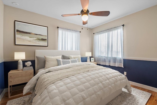 bedroom with hardwood / wood-style floors and ceiling fan