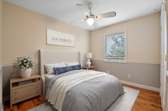 bedroom with ceiling fan and light hardwood / wood-style floors