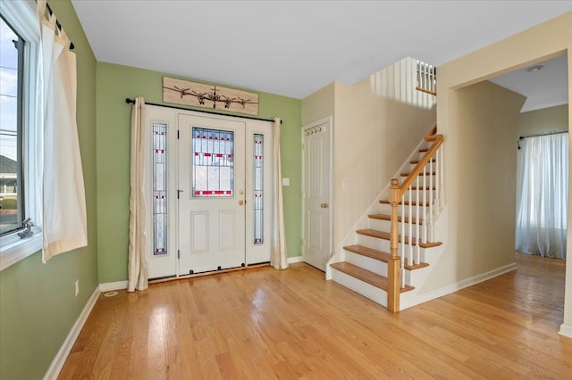 entrance foyer with a wealth of natural light and light hardwood / wood-style floors