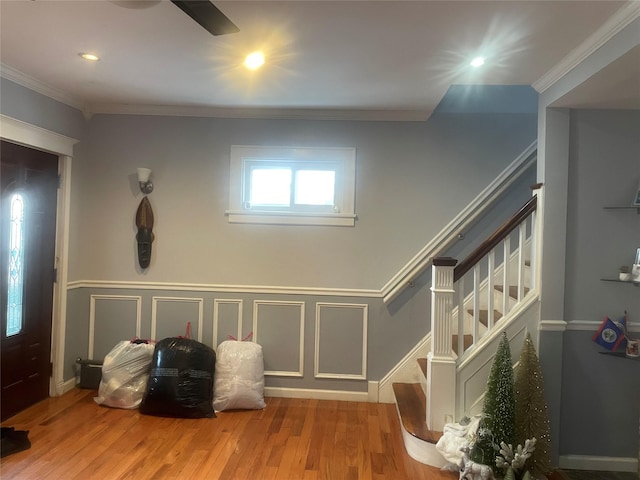 interior space with hardwood / wood-style flooring and ornamental molding