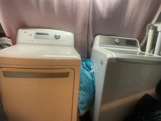 clothes washing area with washer and dryer