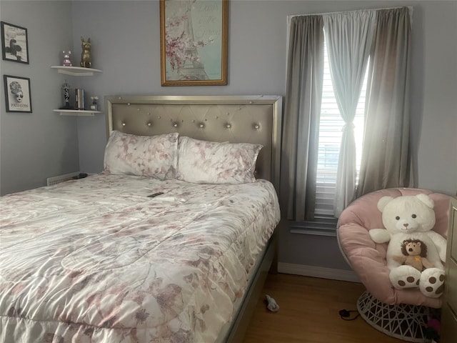 bedroom with wood-type flooring