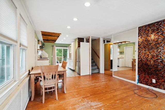 dining room with radiator, recessed lighting, stairway, and light wood-style floors