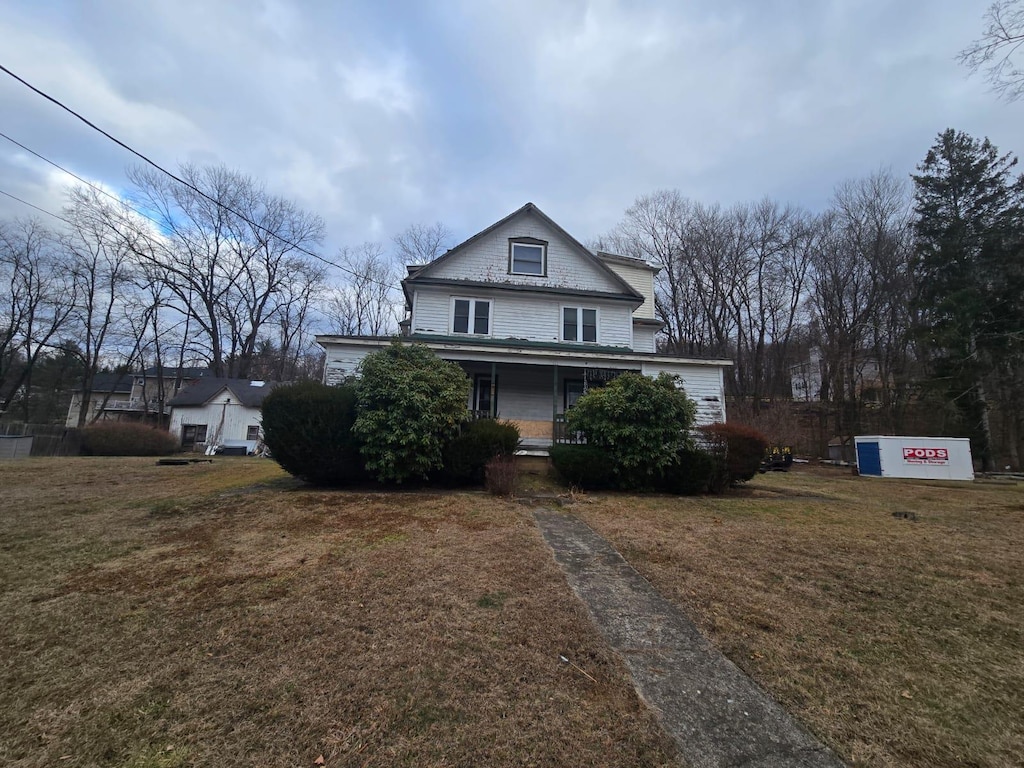 view of front of property with a porch and a front yard