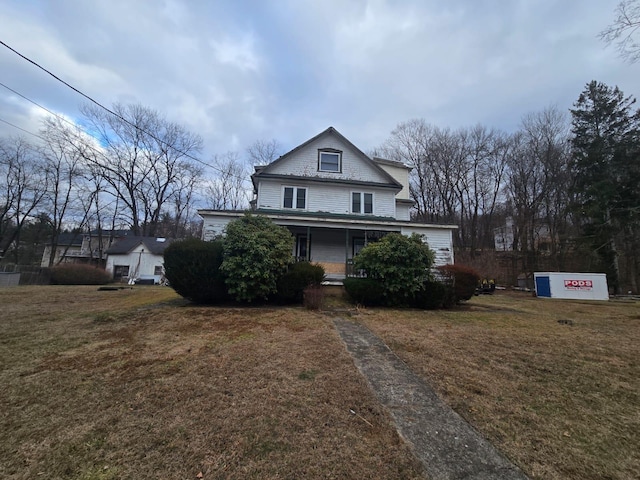 view of front of property with a porch and a front yard