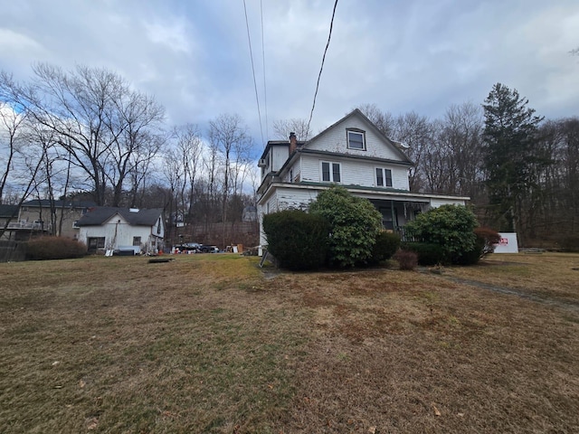 view of side of home with a lawn