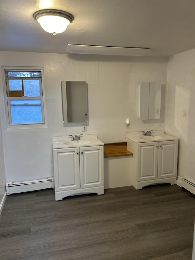 bathroom featuring vanity, wood-type flooring, and baseboard heating