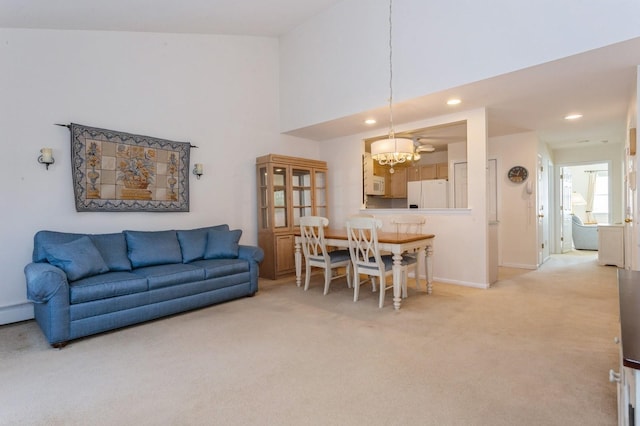 interior space with a high ceiling, carpet flooring, and a chandelier