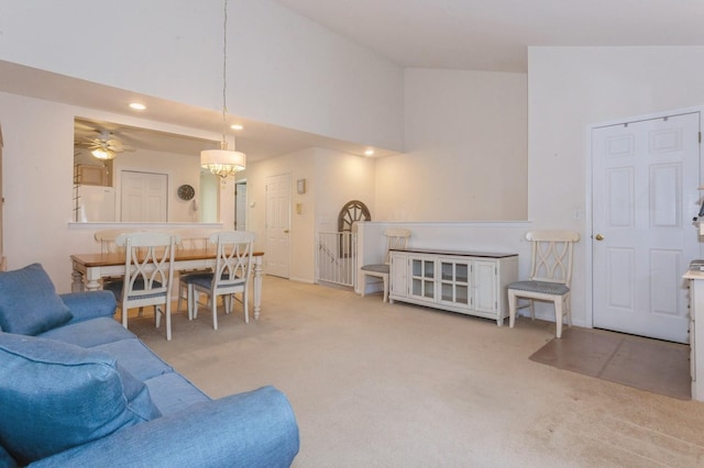 living room featuring ceiling fan, light colored carpet, and high vaulted ceiling