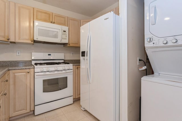 kitchen featuring stacked washer / drying machine, light tile patterned floors, light brown cabinetry, and white appliances